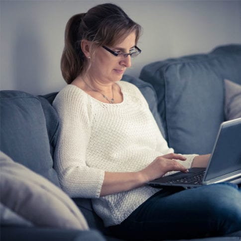 Online learner working at a laptop