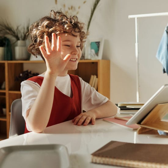 Photo-k12-child-waving-distance-learning_550x550