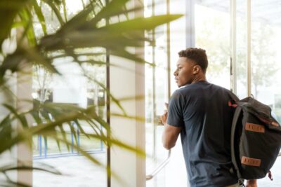 student-walking-out-door